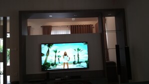 A television mounted on a wall with a two-tone color scheme.