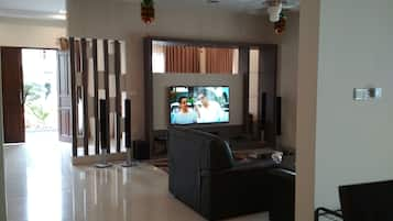 Villa | Living area | 60-inch flat-screen TV with cable channels, TV, DVD player