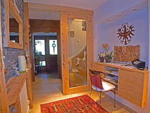 A wooden interior with a desk, chair, and a decorative wall piece. - Vacation apartment Landleben for 4-5 persons - Landhaus Dengg (Gerlos)
