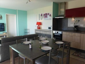 A modern kitchen with a dining area.