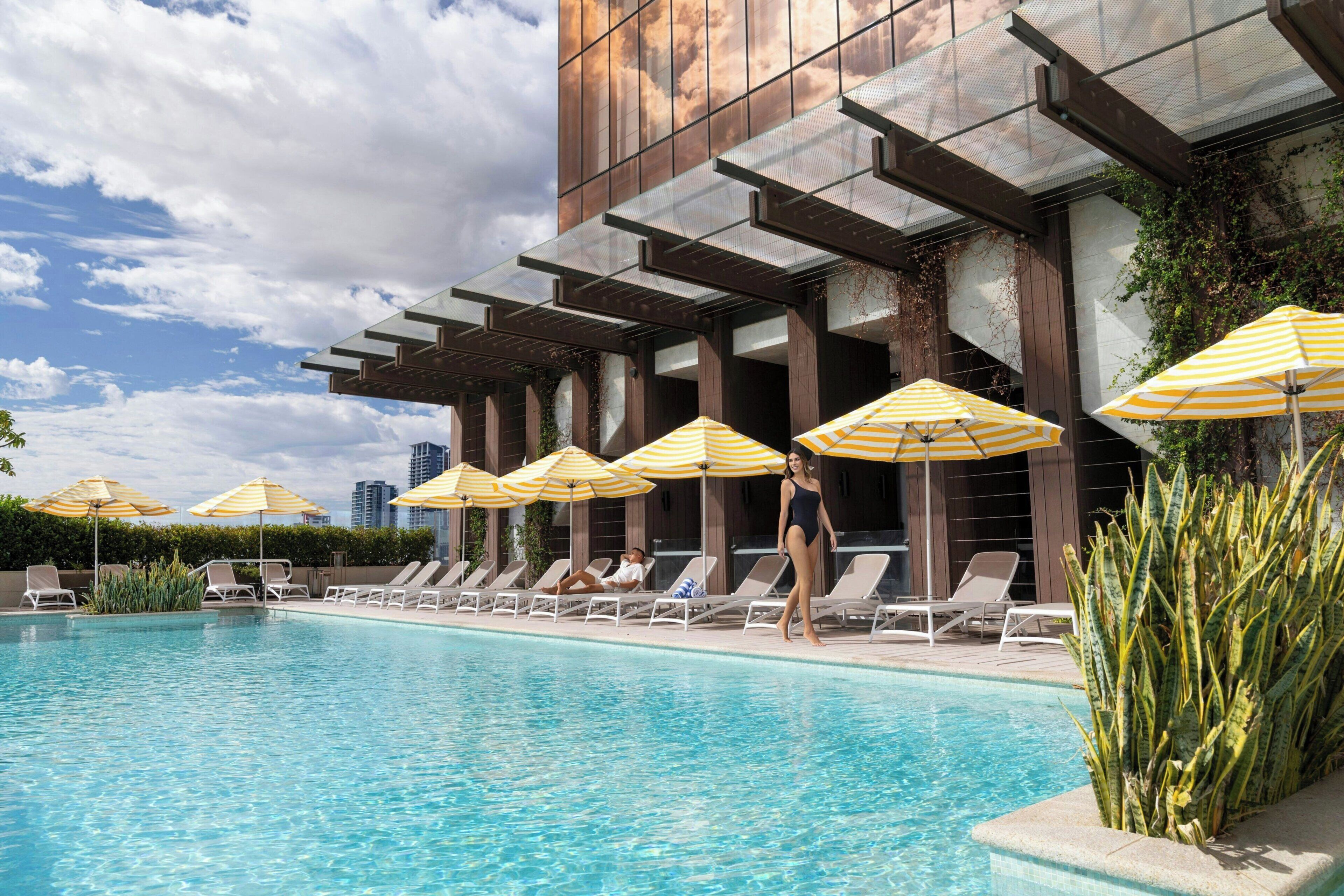 Outdoor pool, open 6 AM to 6 PM, pool umbrellas, pool loungers