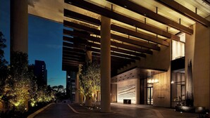 A modern building entrance with a curved pathway, large columns, and a well-lit facade. - The Westin Perth (Perth)