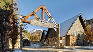 A stone building with a sign reading "Mystic Springs Chalets & Hot Pools".