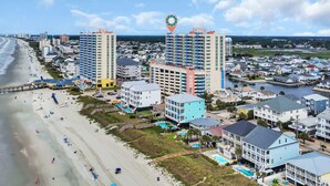 A coastal cityscape with beachfront hotels, a pier, and a marina. - Prince Luxury Ocean View w Sky Pool Lazy River (North Myrtle Beach)