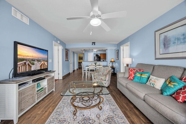 A living room with a TV, sofa, and coffee table.