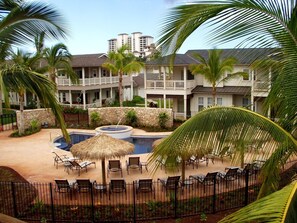 A resort with a swimming pool, lounge chairs, and palm trees. - Ko Olina Coconut Plantation 3BR End-Unit Pool Views & Beach Walk (Kapolei)