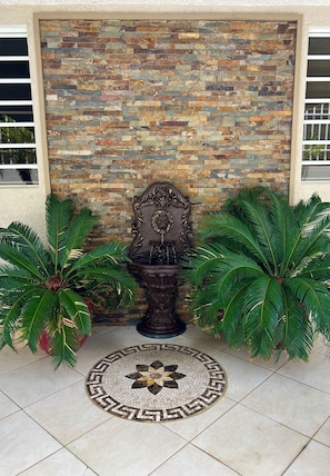 A beautiful grand entrance through the entry gate to the front porch.