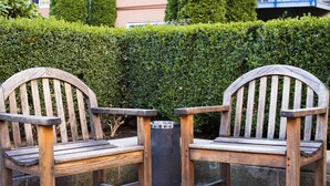 Two wooden chairs with metal legs and a metal trash can between them. - Downtown, 2 BR,WATER VIEW. 98% Walk Score! FREE Parking, Pool, sauna,weight room (Seattle)