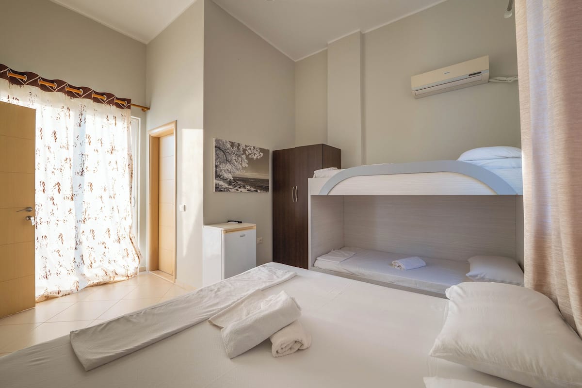 Quadruple Room, Ocean View | 1 bedroom, in-room safe, desk, bed sheets