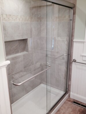 Shower, hair dryer, soap, toilet paper