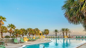 A pool area with lounge chairs and palm trees. - 105E 2Bed/2Bath Beautiful Gulf View (Gulf Shores)