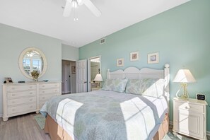 A bedroom with a bed, dresser, nightstand, and a ceiling fan. - 105E 2Bed/2Bath Beautiful Gulf View (Gulf Shores)