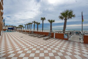 Relax on the outdoor terrace with lounge chairs and a serene view of the water.