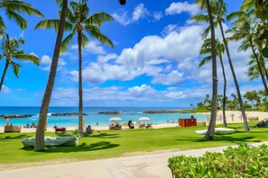 A tropical resort with palm trees, a beach, and a clear sky. - Luxury Ko Olina Beach Villas: Panoramic Ocean View 3BR (Kapolei)
