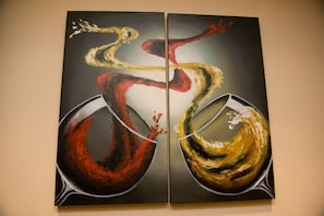 Two abstract paintings on a wall.