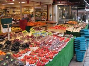 A fruit and vegetable market with various produce displayed in bins and boxes. - Eiffel-Invalides, New & Elegant  (Paris)
