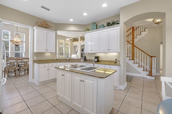 Kitchen with central island, stove, and ample counter space.