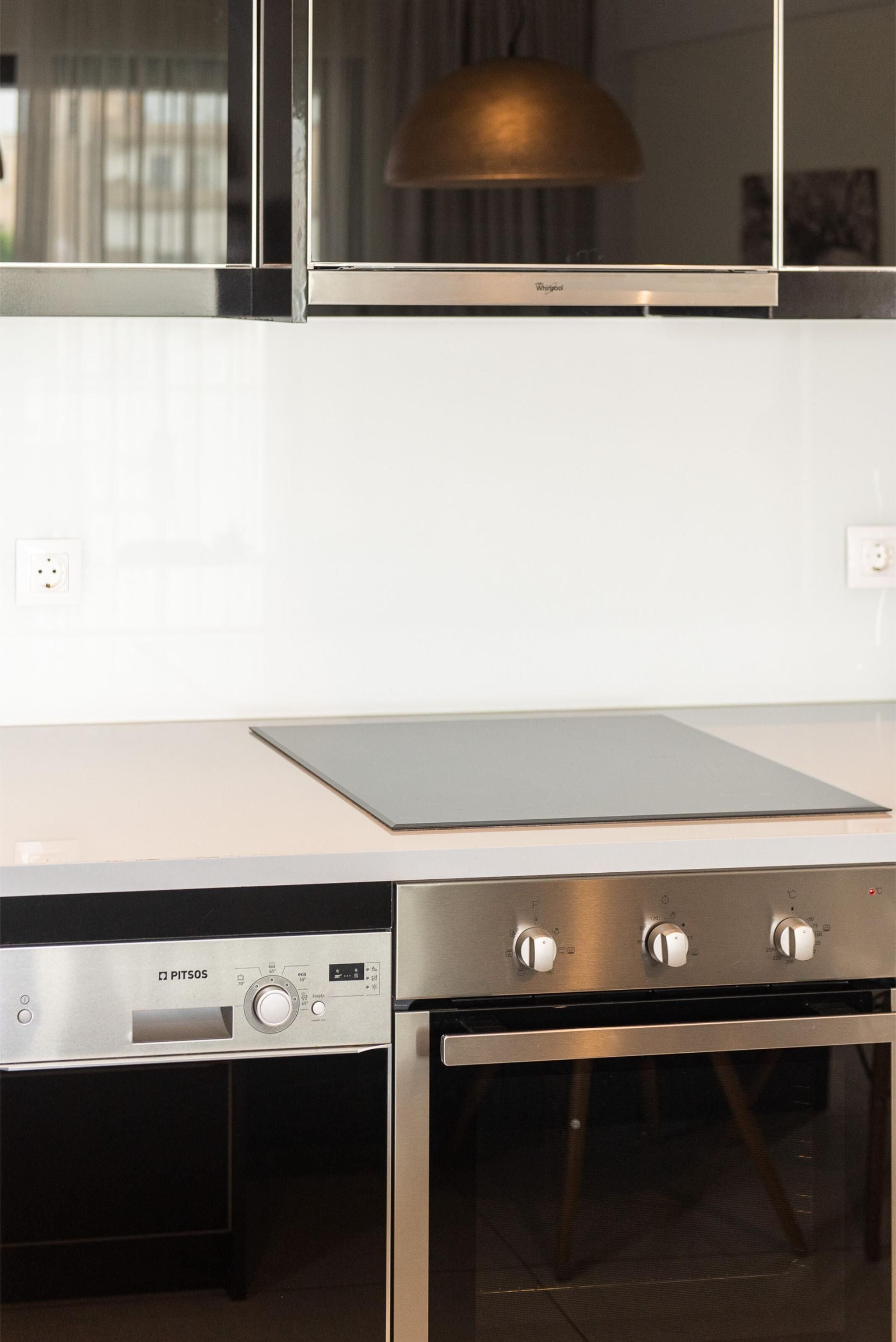 A kitchen with a built-in dishwasher, a stove, and a microwave.