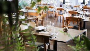 A restaurant with wooden tables and chairs, some with plates and glasses set. - Belle Escapes - Latania Villa Palm Cove (Palm Cove)