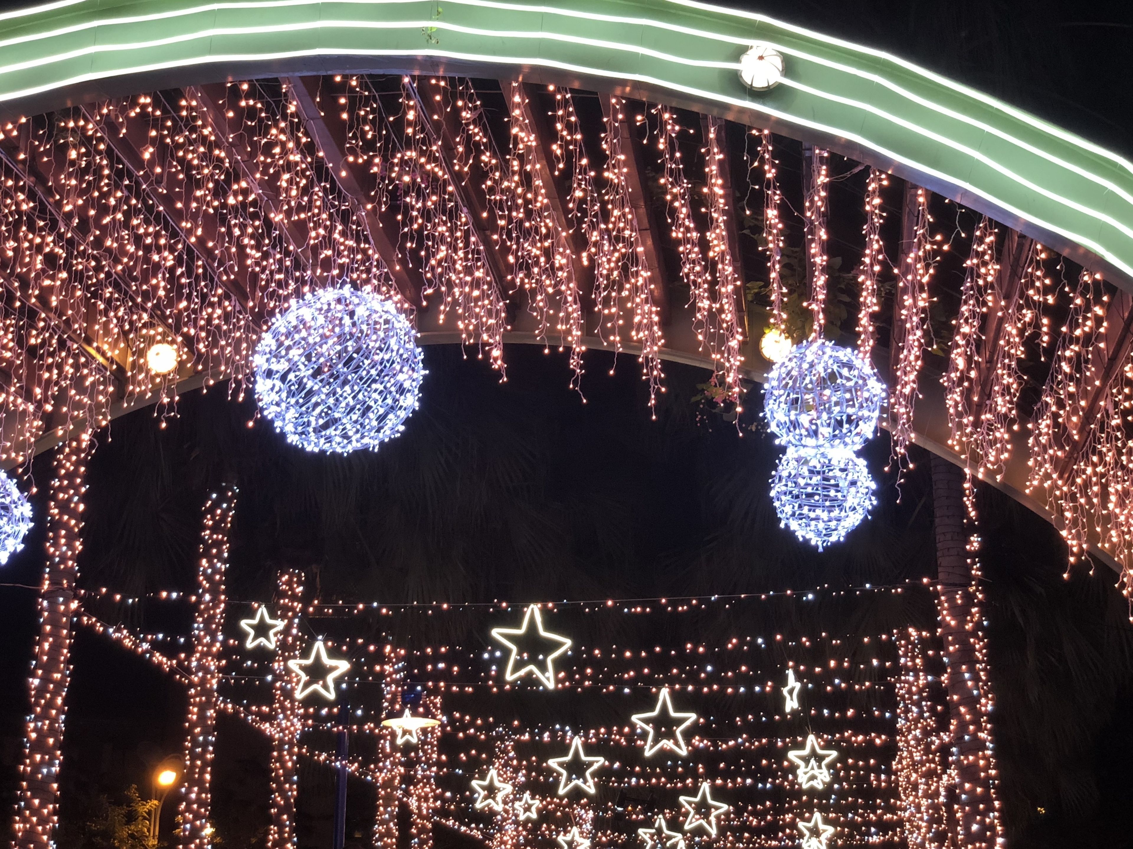 A covered outdoor area with string lights and star-shaped decorations.