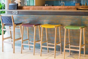 A bar area with wooden stools and a bar counter.