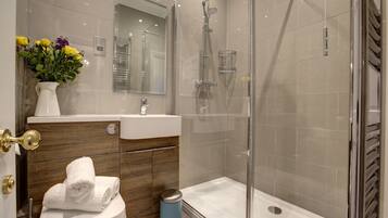 Shower, hair dryer, towels, toilet paper