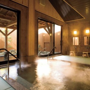 A hot spring area with a wooden interior, a glass door leading outside, and a small wooden bench. - Shunsai no Yado Seasonal Inn Ryokusuitei (Kamogawa)
