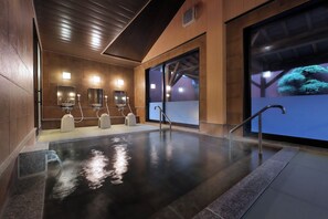 A modern indoor pool area with a reflective floor, multiple mirrors, and a large window with a view of trees. - Shunsai no Yado Seasonal Inn Ryokusuitei (Kamogawa)