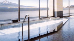 A pool area with large windows and a view of a mountain. - Mitsui Kanko Hotel (Rebun)