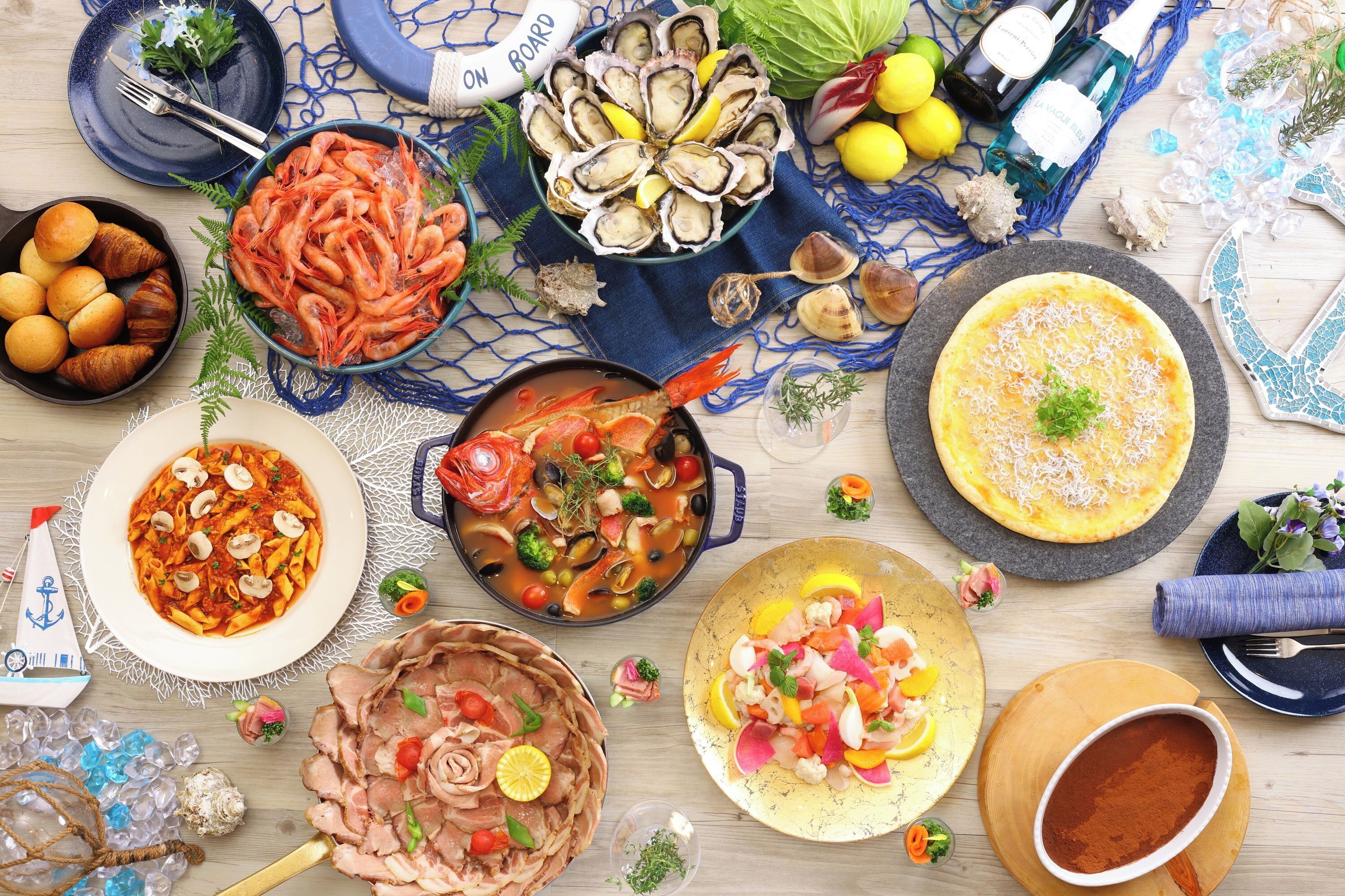 A variety of seafood dishes, including oysters, shrimp, and a seafood salad, arranged on a wooden table.