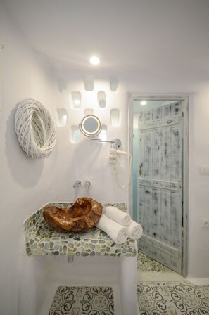Bathroom features a sink with mosaic tile backsplash, decorative bowl, and a mirror above.