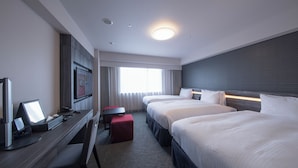 A hotel room with a desk, two beds, a TV, and a window with curtains. - Richmond Hotel Kumamoto Shinshigai (Kumamoto)
