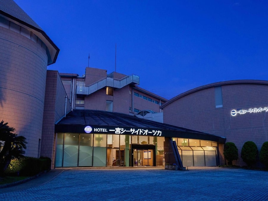 A hotel with a modern design, featuring a curved facade and a prominent entrance.