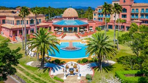 A resort with a central pool, palm trees, and a dome-shaped building. - Ooedo Onsen Monogatari Premium Saikaibashi (Sasebo)