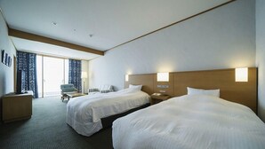A hotel room with two beds, a desk, a chair, and a view of the outdoors. - Hotel Passage Kinkai (Nagasaki)