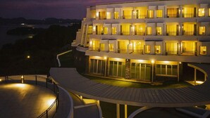 A multi-story hotel with balconies and a pool area. - Hotel Passage Kinkai (Nagasaki)