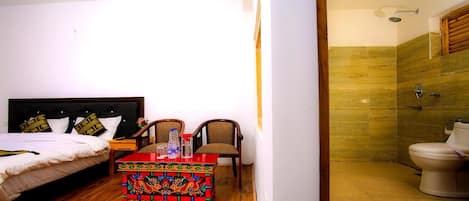 A bedroom with a bed, bedside table, and a colorful decorative box.