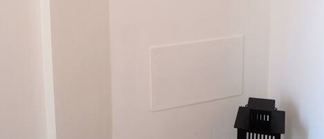 A wall with multiple framed pictures depicting various landscapes and scenes.