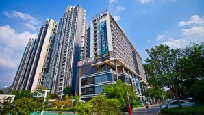 A high-rise building with multiple floors, large windows, and a prominent entrance. - Jasmine International Hotel (Changsha)