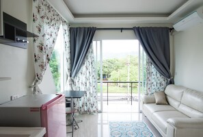 Superior Apartment with Balcony  | Living area | Flat-screen TV - The Most Advantageous Apartment Phuket (Rawai)