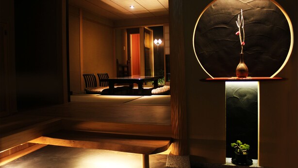 A modern interior with a dining area, a staircase, and a circular light fixture. - Kyomachiya Ebisu (Kyoto)