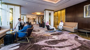 A spacious lobby with a modern design, featuring a large, patterned carpet, comfortable seating areas, and a chandelier. - Braira Al Wezarat (Riyadh)