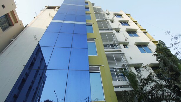 A multi-story building with a modern design, featuring a mix of glass and concrete facades. - Hotel Star Park (Chittagong)