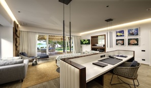 A modern hotel room with a large dining table, a sofa, and a TV.