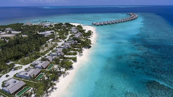 On the beach, white sand, sun loungers, beach umbrellas