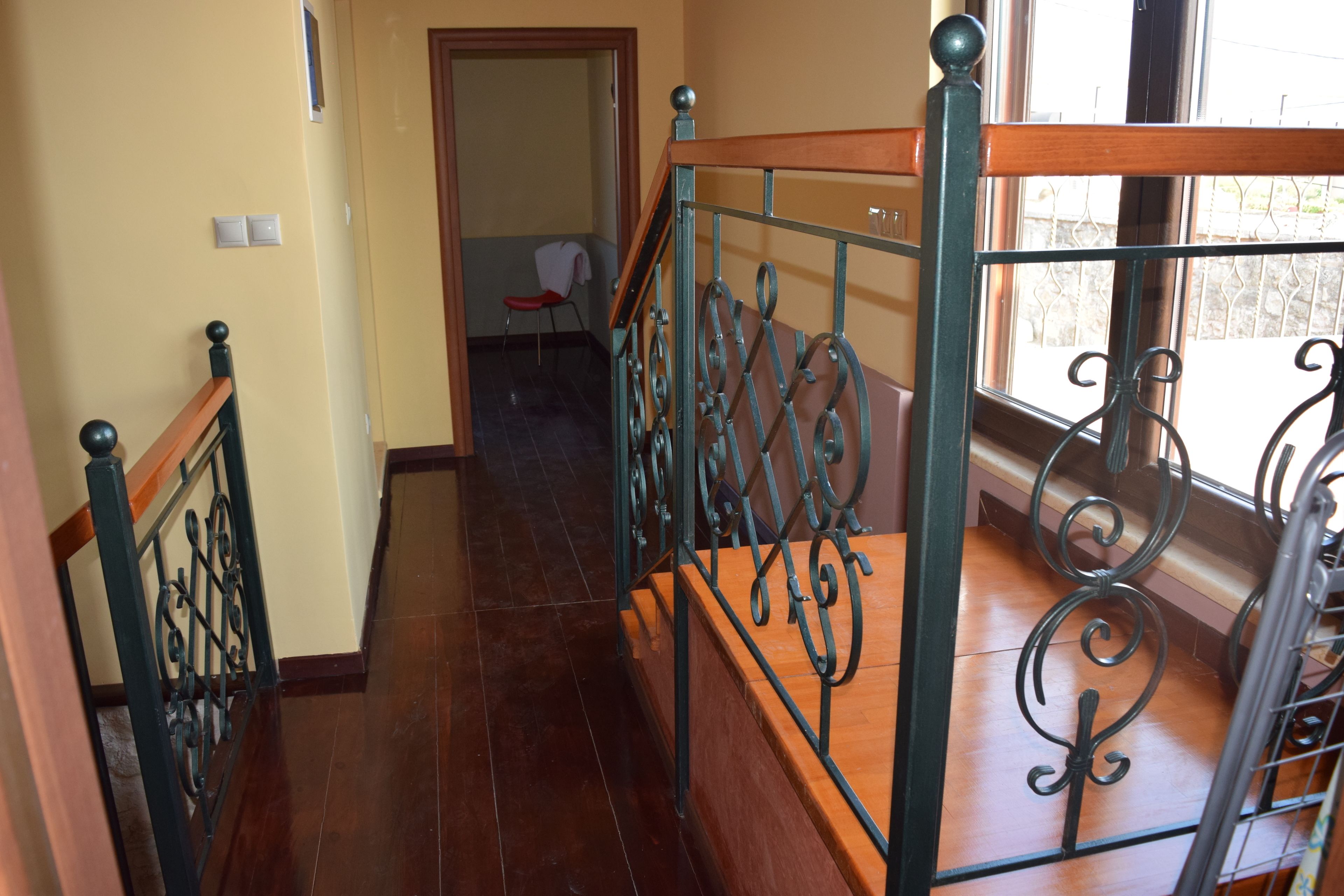 A staircase with ornate metal railings and wooden steps.