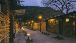 A corridor with wooden buildings, street lamps, and a fire extinguisher. - Guanwu Villa (Taian)