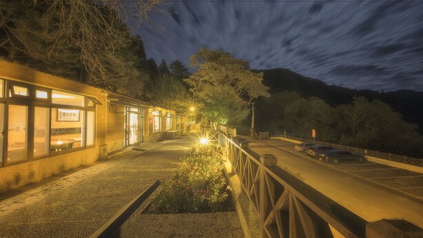 A building with a paved walkway and a garden area. - Guanwu Villa (Taian)