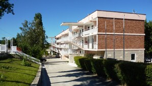 A multi-story building with balconies, a staircase, and a paved pathway. - Hotel Zarya- All Inclusive Light (Golden Sands)