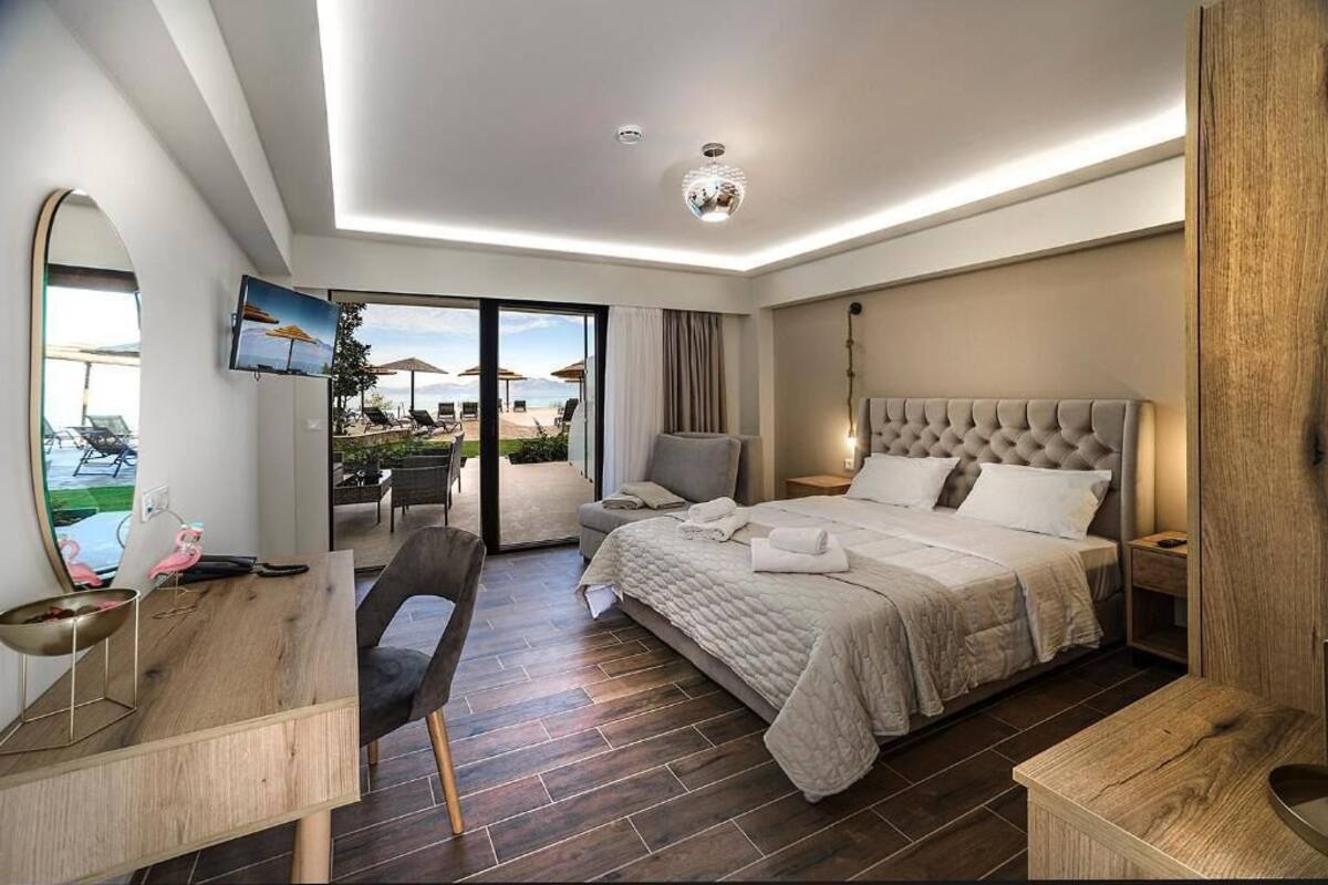 Una habitación de hotel moderna con una cama grande, un escritorio, una silla y un televisor.